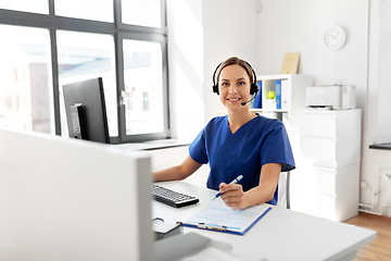 Image showing doctor with headset and computer at hospital