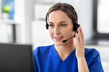 Image showing doctor with headset and computer at hospital