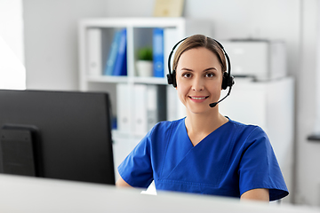 Image showing doctor with headset and computer at hospital