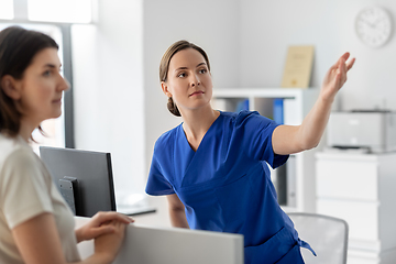 Image showing doctor showing something to patient at hospital