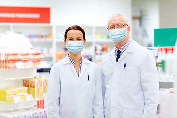 Image showing apothecaries wearing medical masks at pharmacy