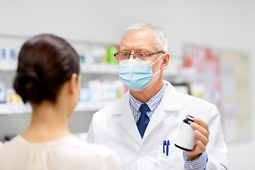 Image showing apothecary in mask showing drug to customer