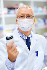 Image showing old apothecary in mask with medicine at pharmacy