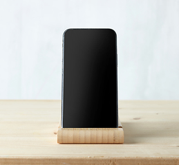 Image showing smartphone on light wooden table