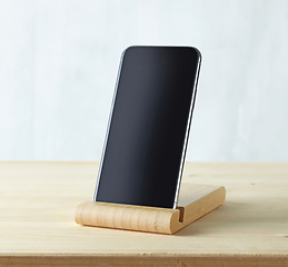 Image showing smartphone on light wooden table