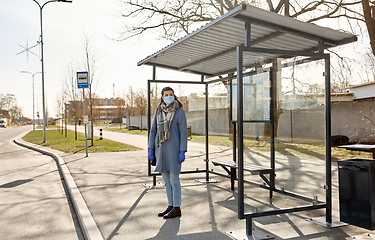 Image showing young woman wearing medical mask at bus stop