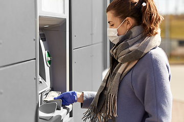 Image showing woman in medical mask and glove with money at atm