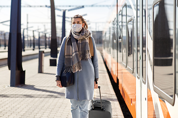 Image showing woman in protective face mask at railway station