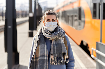 Image showing woman in protective face mask at railway station
