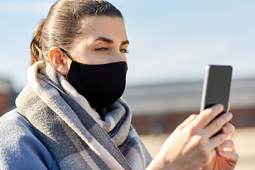 Image showing woman in face mask with smartphone in city