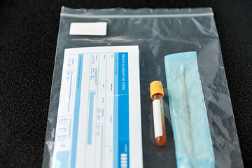 Image showing beaker with test, cotton swab and medical report