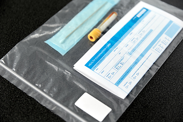 Image showing beaker with test, cotton swab and medical report