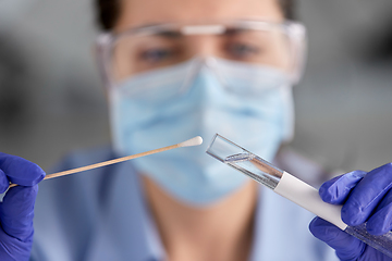 Image showing doctor holding beaker with coronavirus test