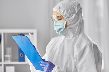 Image showing doctor in medical mask and goggles with clipboard