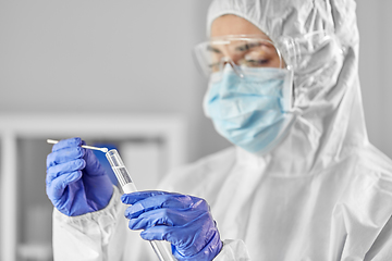Image showing scientist holding beaker with coronavirus test