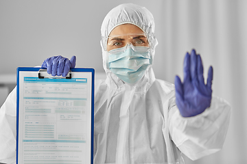 Image showing doctor in medical mask and goggles with clipboard