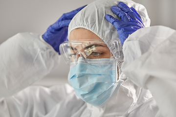 Image showing doctor in protective wear, medical mask and gloves