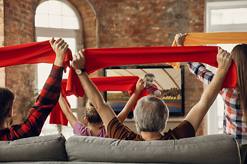 Image showing Excited, happy big family team watch sport match together on the couch at home