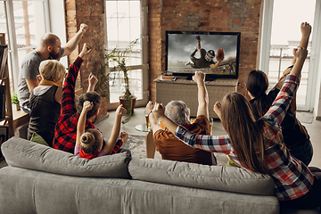 Image showing Excited, happy big family team watch sport match together on the couch at home