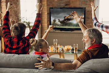 Image showing Excited, happy big family team watch sport match together on the couch at home