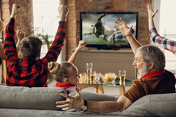 Image showing Excited, happy big family team watch sport match together on the couch at home