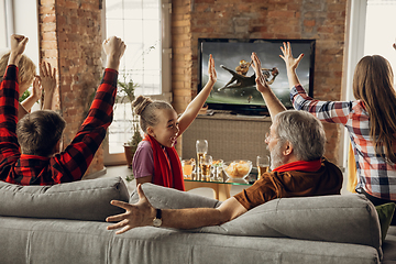 Image showing Excited, happy big family team watch sport match together on the couch at home