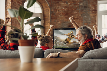 Image showing Excited, happy big family team watch sport match together on the couch at home