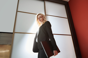 Image showing Young adult business woman wearing formalwear and carrying the l