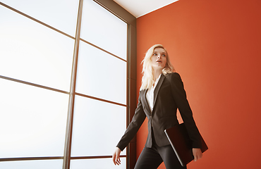 Image showing Young adult business woman wearing formalwear and carrying the l