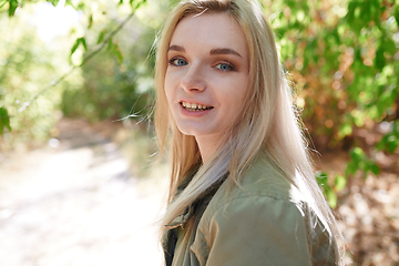 Image showing Young adult woman spending quality time in the forest