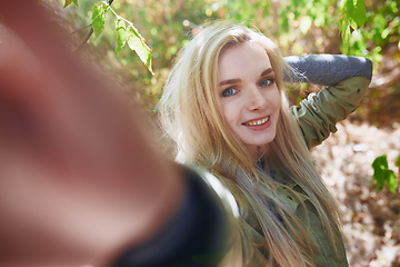 Image showing Young adult woman spending quality time in the forest