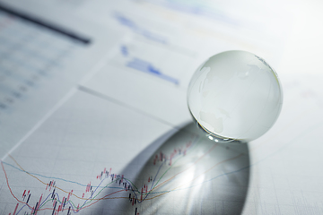Image showing Glass globe on stock market chart