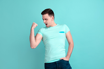 Image showing Caucasian young man\'s portrait on blue studio background