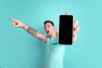 Image showing Caucasian young man\'s portrait on blue studio background