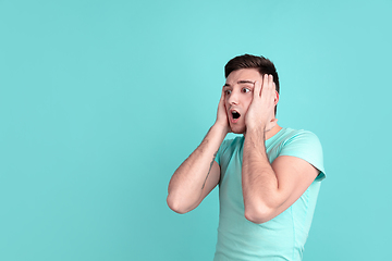 Image showing Caucasian young man\'s portrait on blue studio background