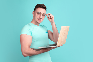 Image showing Caucasian young man\'s portrait on blue studio background