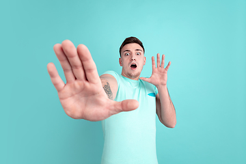 Image showing Caucasian young man\'s portrait on blue studio background