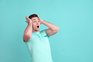 Image showing Caucasian young man\'s portrait on blue studio background