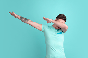 Image showing Caucasian young man\'s portrait on blue studio background