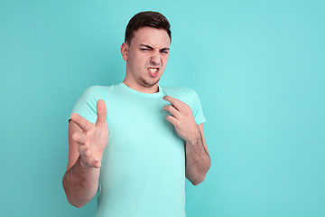 Image showing Caucasian young man\'s portrait on blue studio background