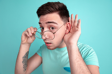 Image showing Caucasian young man\'s portrait on blue studio background