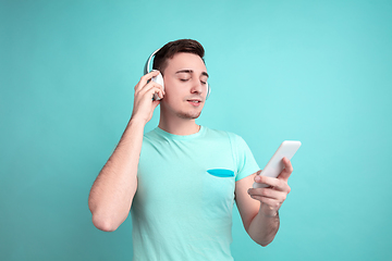 Image showing Caucasian young man\'s portrait on blue studio background