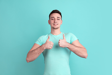 Image showing Caucasian young man\'s portrait on blue studio background