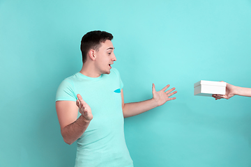 Image showing Caucasian young man\'s portrait on blue studio background