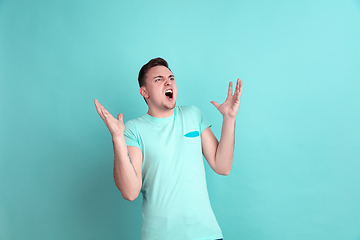 Image showing Caucasian young man\'s portrait on blue studio background