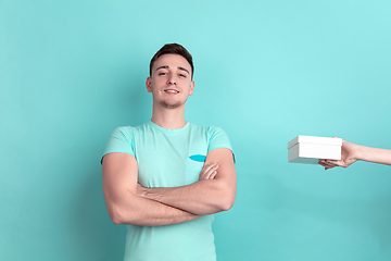 Image showing Caucasian young man\'s portrait on blue studio background