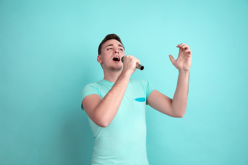 Image showing Caucasian young man\'s portrait on blue studio background