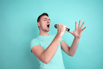 Image showing Caucasian young man\'s portrait on blue studio background