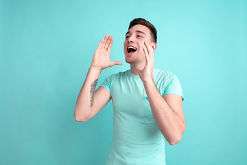 Image showing Caucasian young man\'s portrait on blue studio background