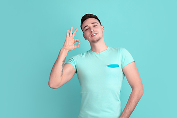 Image showing Caucasian young man\'s portrait on blue studio background